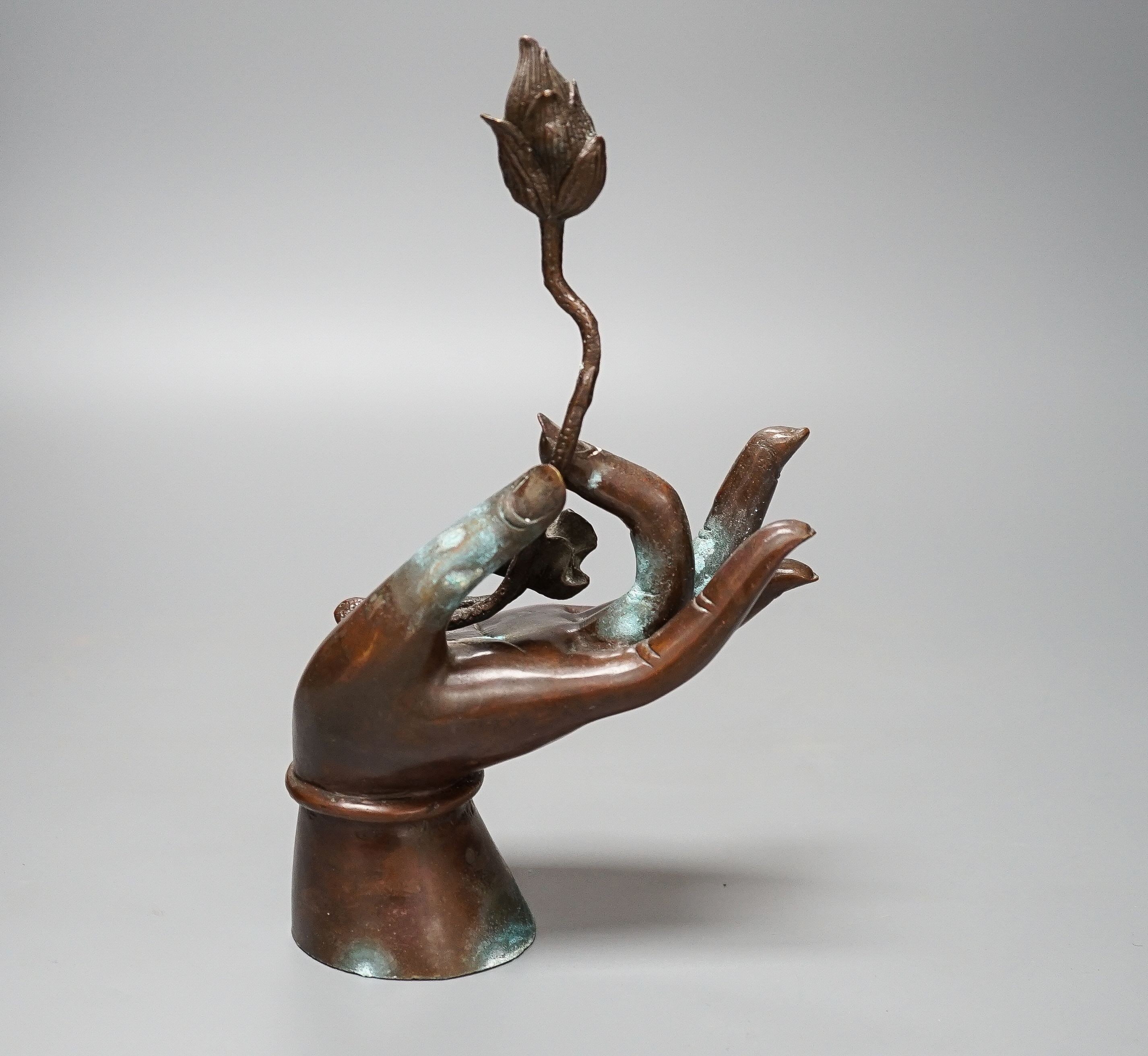 A Himalyan bronze Bodhisattva’s hand, holding a lotus flower 22cm